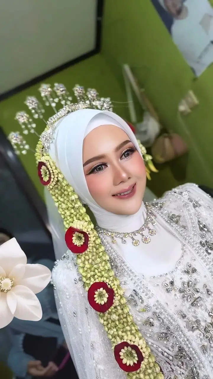 Makeup akad Putri berhijab putih dengan siger dan ronce melati berhias mawar merah